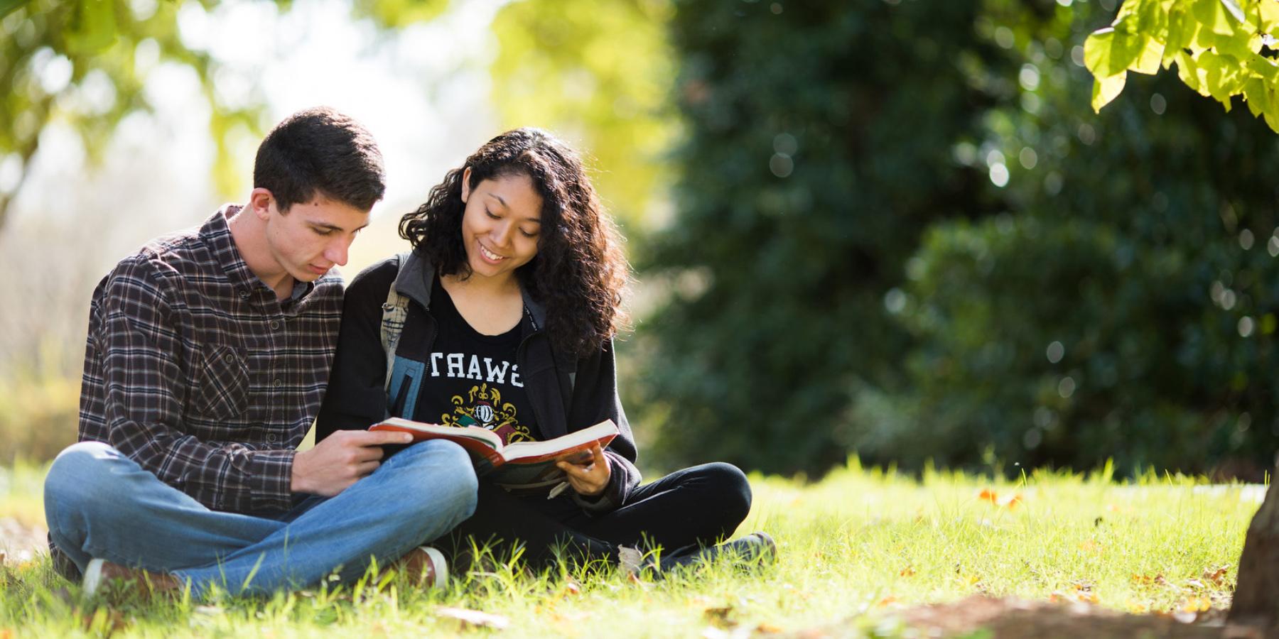 two student reading outside