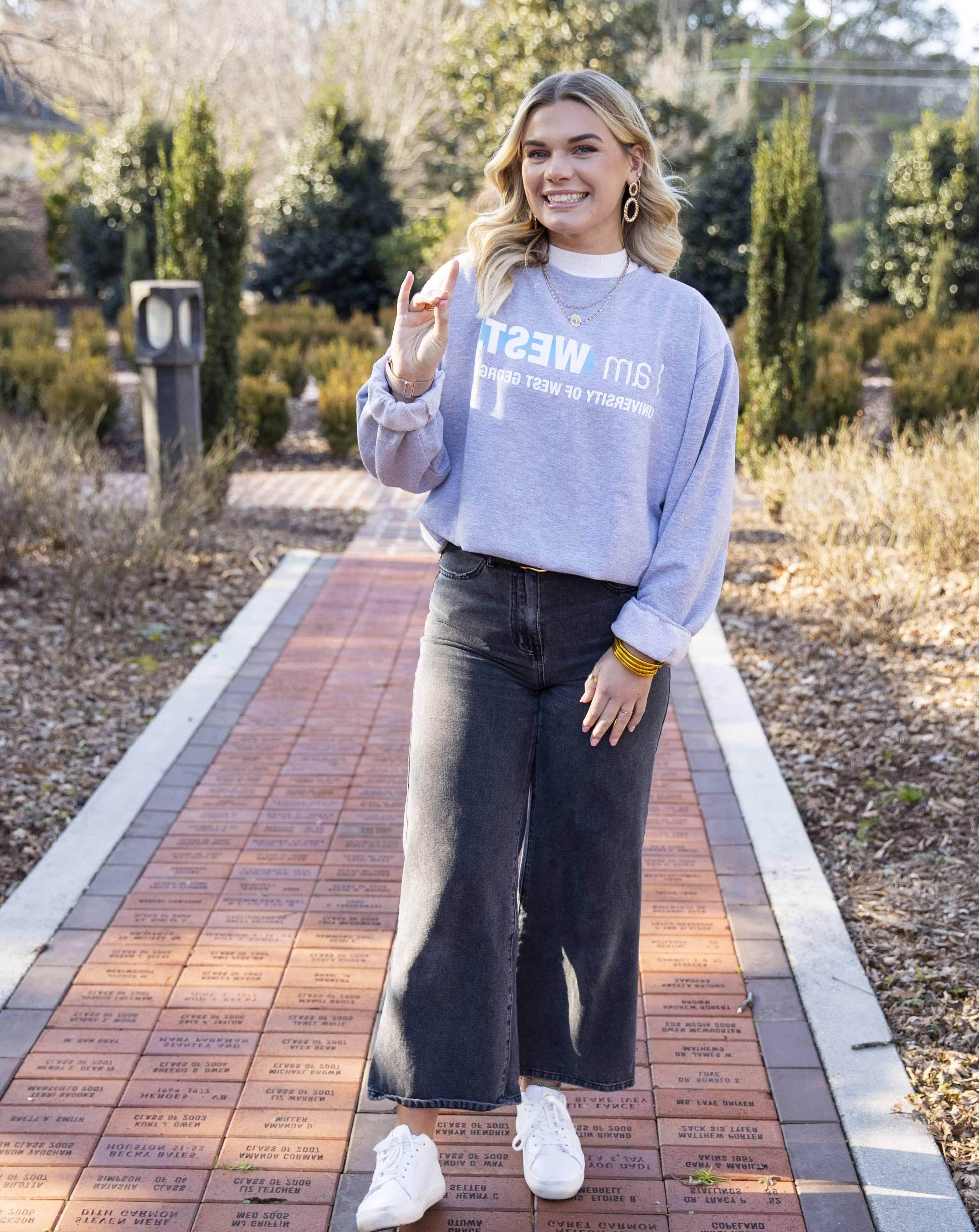 Jacey Coleman posing for an outside portait in the alumni garden.